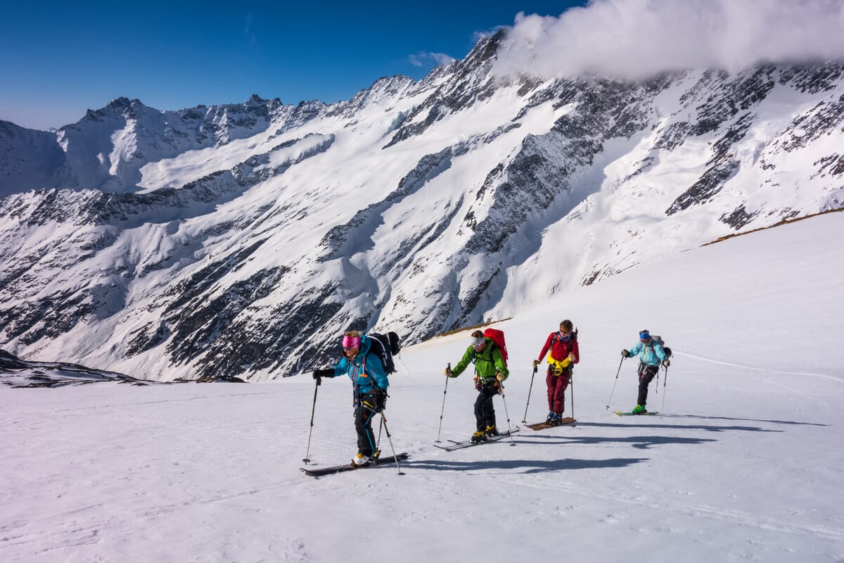 Skitourengruppe auf der Urner Haute Route in verschneiter Winterlandschaft im Aufstieg